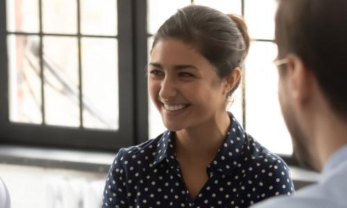 Human Services Worker with Associate Degree Smiling in Community Meeting 