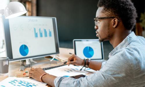 Data Analytics Student Analyzing Graphs on Computer 