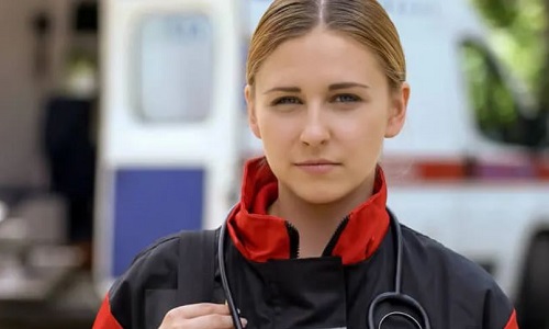 EMT with Certificate in Birmingham Standing Outside Ambulance