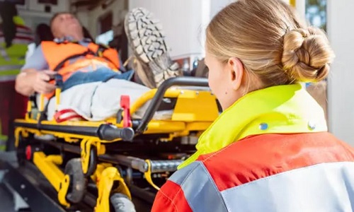 EMT Paramedic with Diploma in Birmingham Loading Patient Into Ambulance