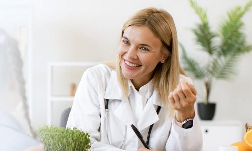 Nebraska family nurse practitioner smiling with pediatric patient during appointment 