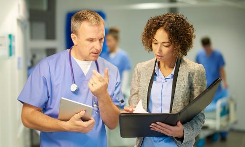 Healthcare Administration Master Degree Holder Speaking with Doctor 