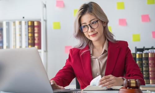 Legal studies graduate working from home on laptop 