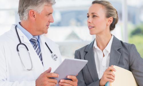 Healthcare Administrator Consulting with Doctor