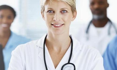 Nurse executive smiling with medical team in background