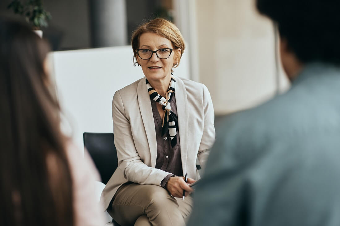 Social Worker with Group of Clients Discussing Mental Health