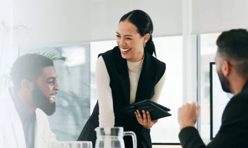 Business analyst smiling with team during weekly meeting