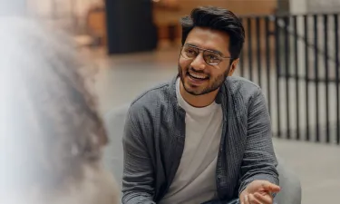 MBA graduate in Hawaii at first job smiling with team member during meeting