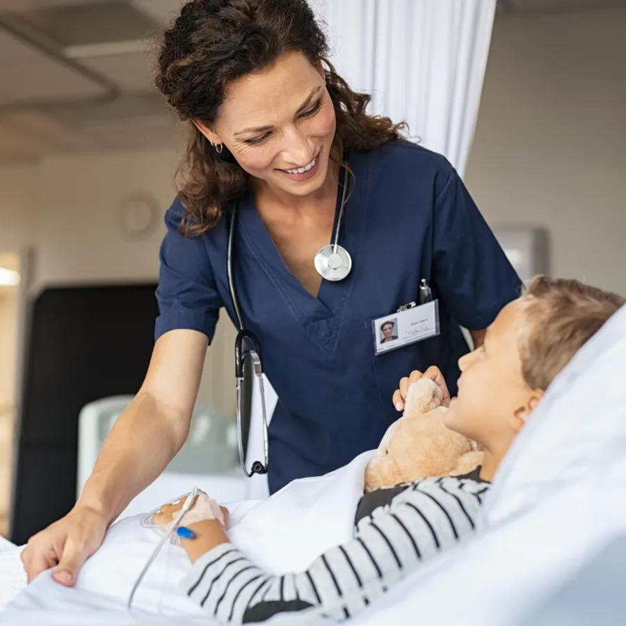 Nurse Smiling with Pediatric Patient in Hospital