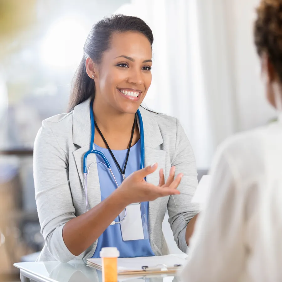 Public Health Nurse with Certificate Speaking with Patient During Appointment