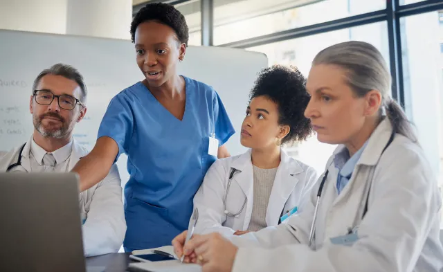 Healthcare team including RN and nurse practitioner discussing patient data