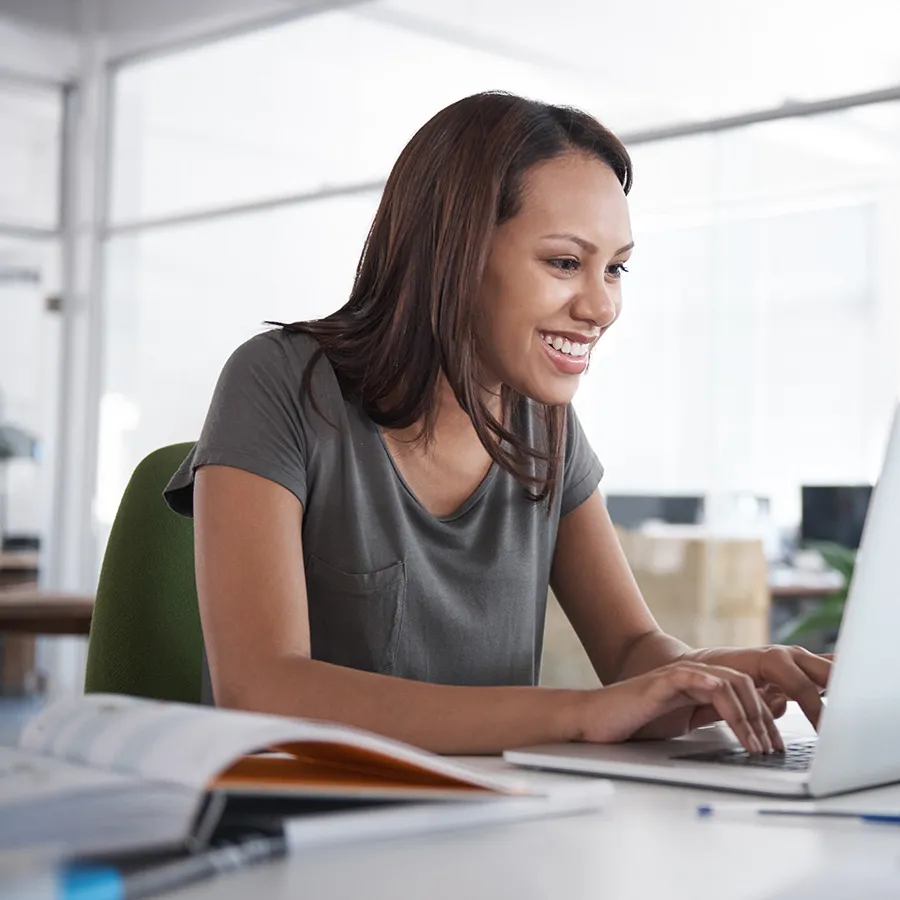 Online nursing student seated at laptop in home