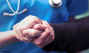 Psychiatric Mental Health Nurse Practitioner Holding Hands with Patient