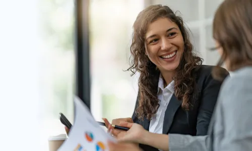 Project manager with bachelor's degree smiling during meeting