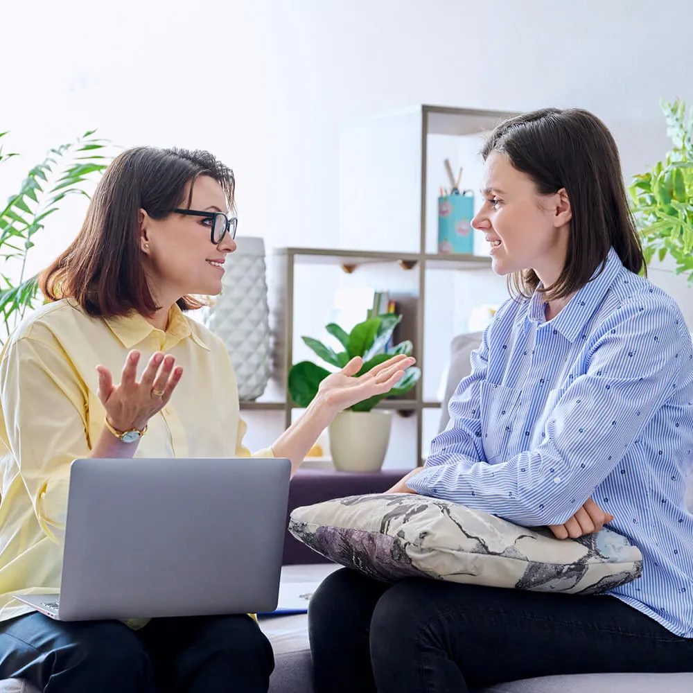 Psychologist with Laptop Speaking with Patient