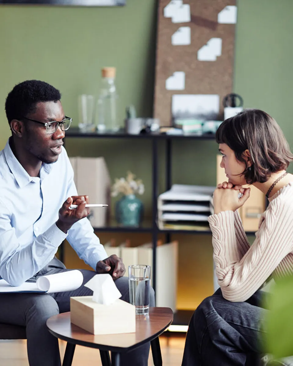 Psychology Degree Graduate Speaking with Client