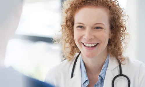 Public health nurse with DNP smiling during staff meeting